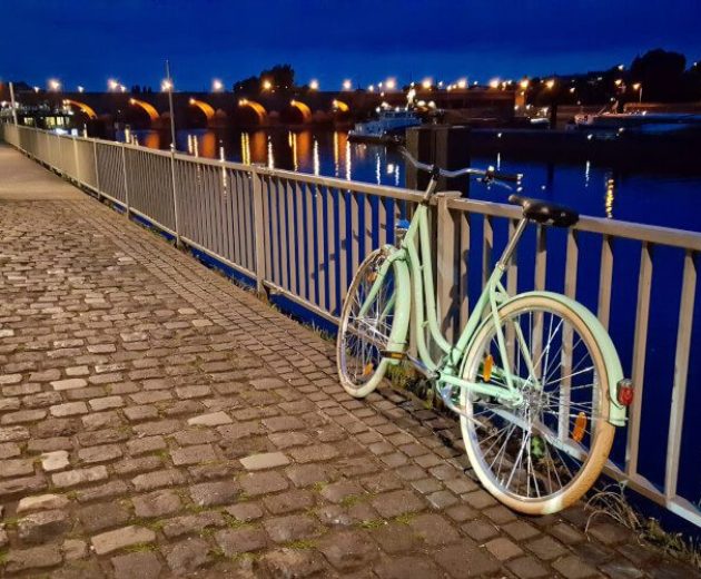 Lone bicycle on a pedestrian walkway during the blue hour in Koblenz, Germany